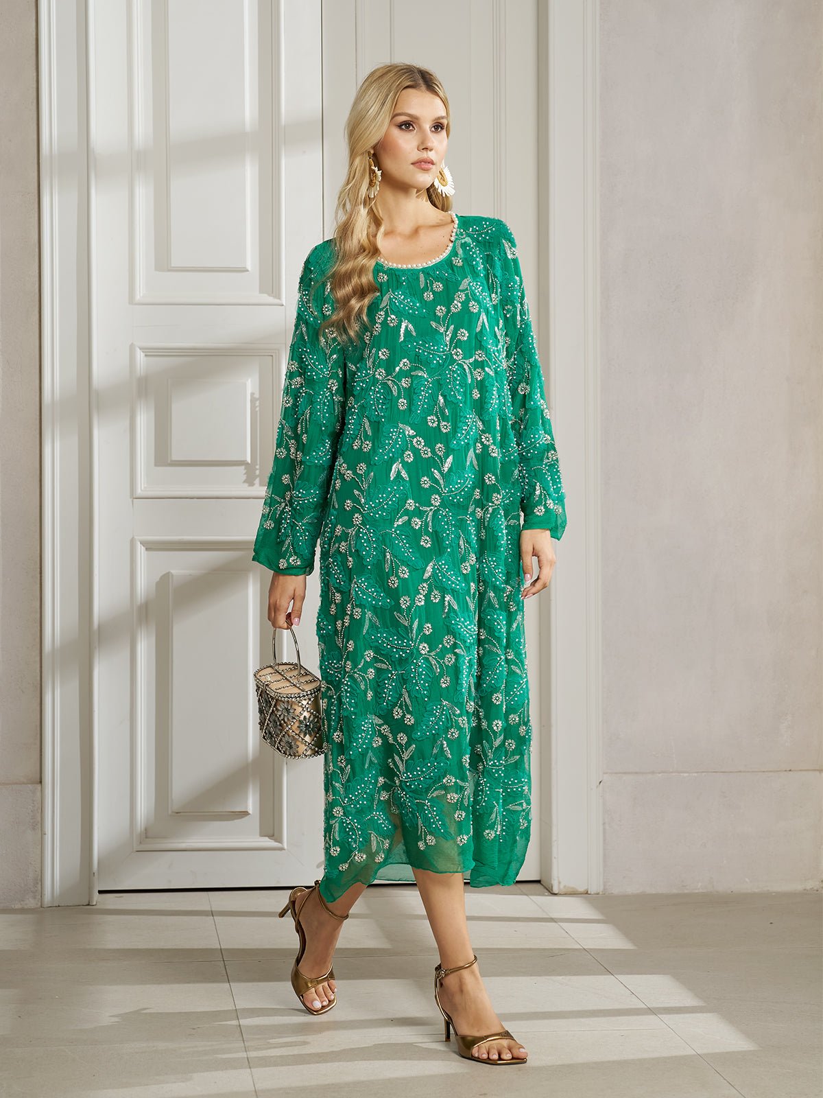 Woman in the Social Queen 100% Silk Beaded Embroidery Dress, paired with gold sandals and a small snakeskin handbag, standing indoors by a white door.