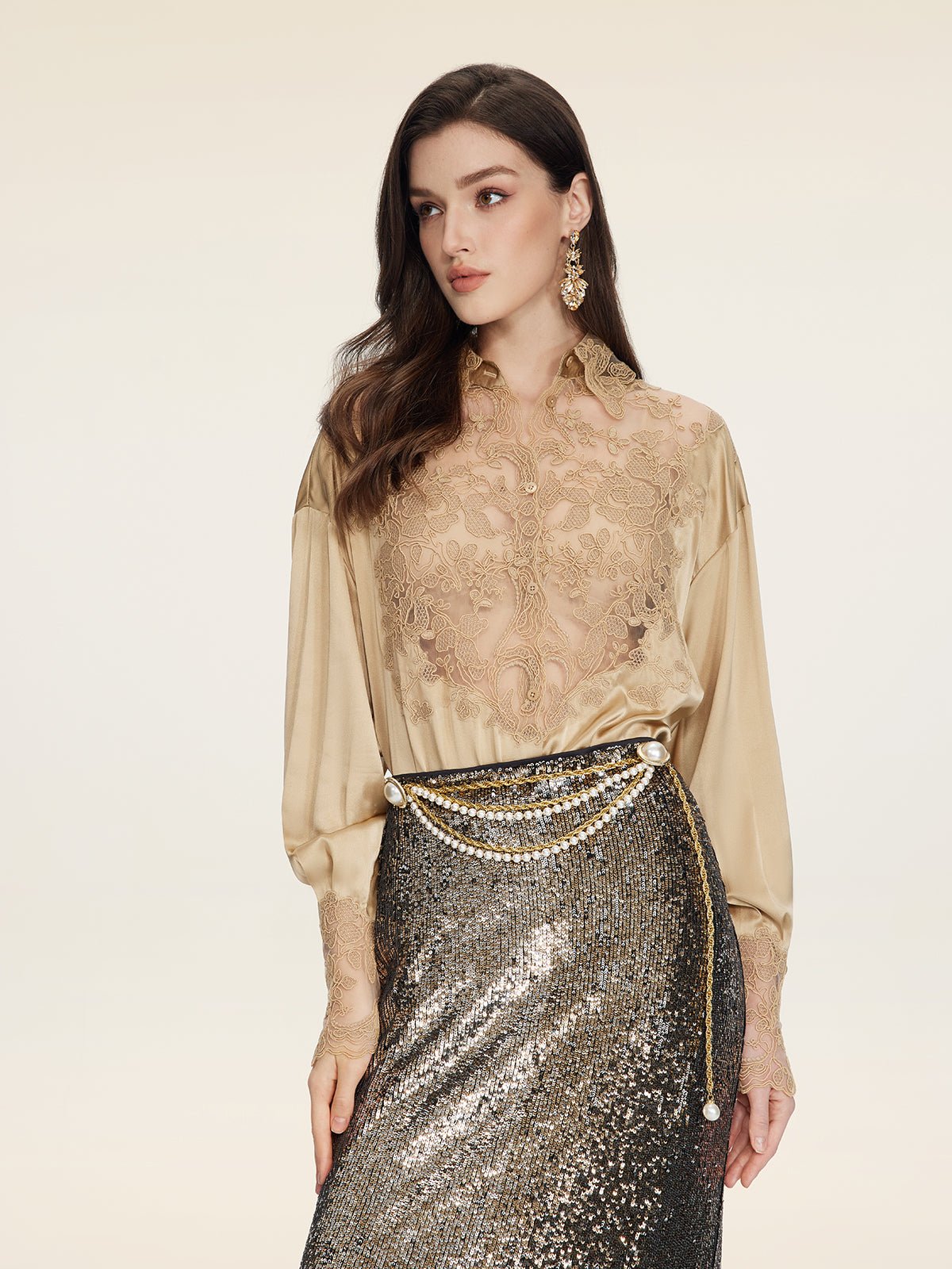 A woman in a Social Queen 100% Silk Embroidered Lace Satin Blouse, pairing it with a metallic sequin skirt and a gold chain belt, poses against a plain light background.