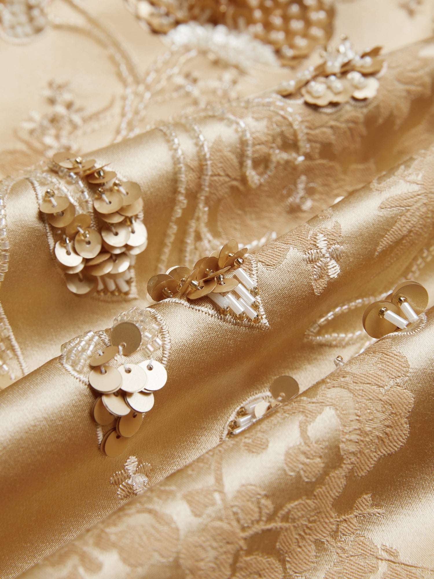 Close-up of the Social Queen 100% Silk Floral Embroidered Satin Jacket, showcasing hand-embroidered jacquard floral patterns with sequin clusters for a textured, reflective look.