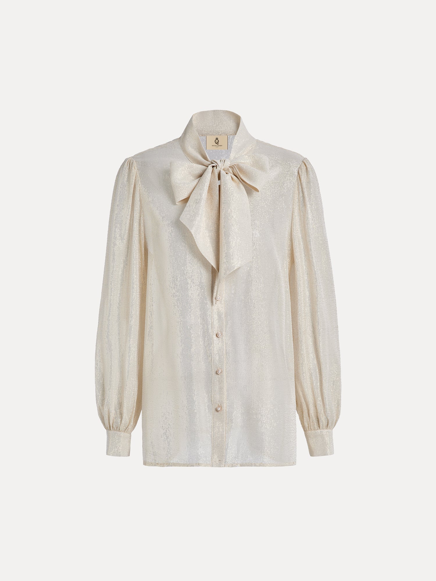 The Social Queen 100% Silk Metallic Ribbon-Tie Blouse features long puff sleeves, a cream hue, a button-down front, and a large bow at the neck, shown on a plain white background.