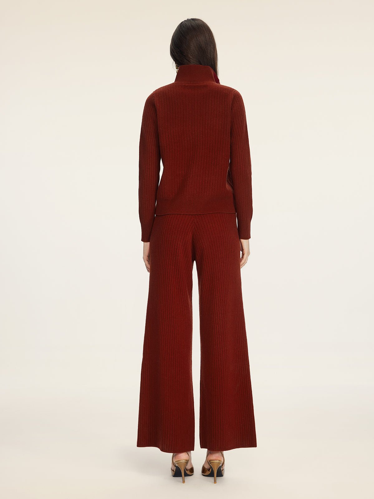 A person stands facing away, wearing the Social Queen 100% Wool Knit Jacket in burgundy with wide-leg pants and heels, against a plain light background.