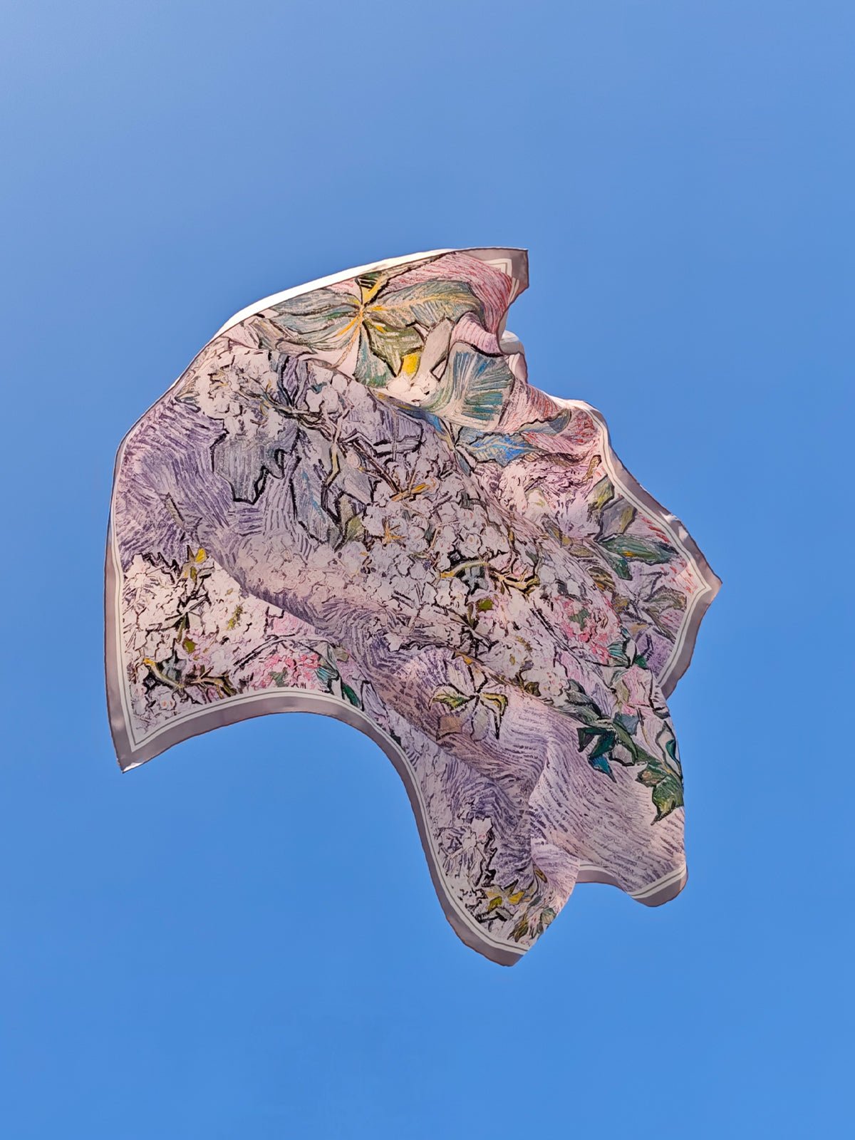 The Social Queen Art Silk Print Scarf features a colorful, abstract floral design against blue—an art-inspired accessory perfect for weddings or elevating any outfit.