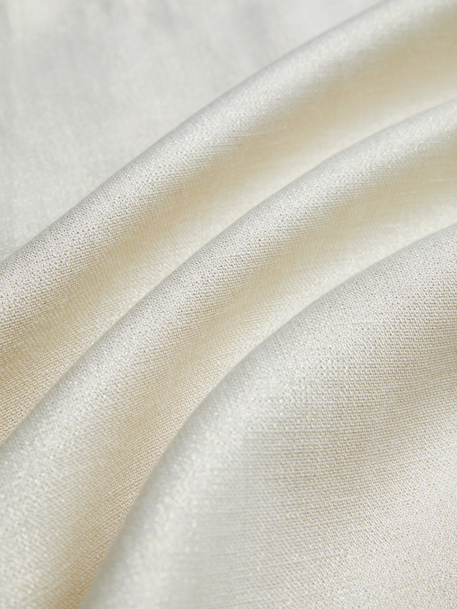 Close-up of the Embroidered Wool Jacket with Pearl Accents by Social Queen, featuring smooth cream fabric, gentle folds, subtle sheen, and delicate hand-embroidered floral motifs.