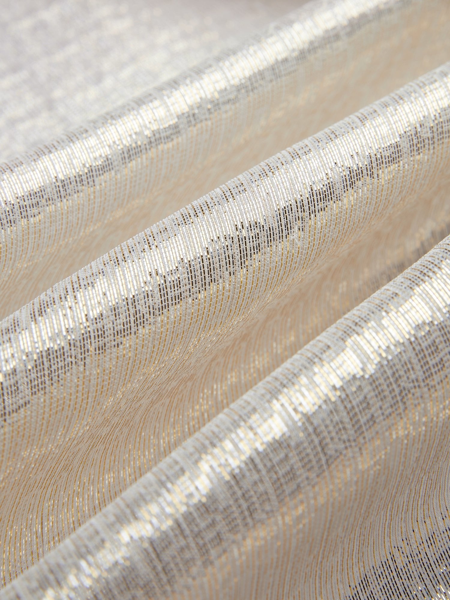 Close-up of the Ethereal Metallic Ruffle Silk Blouse by Social Queen, featuring shimmering gold threads and soft, wavy textured folds.