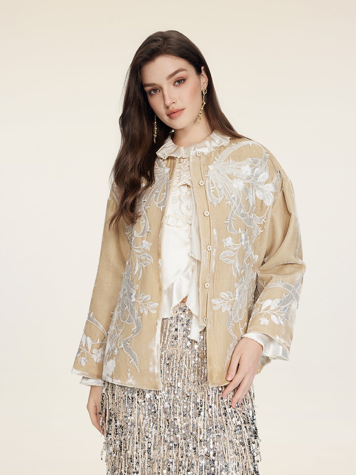 A woman models the Social Queen Floral Embroidered Velvet Jacket over a white blouse and silver sequin skirt, set against a plain light background.