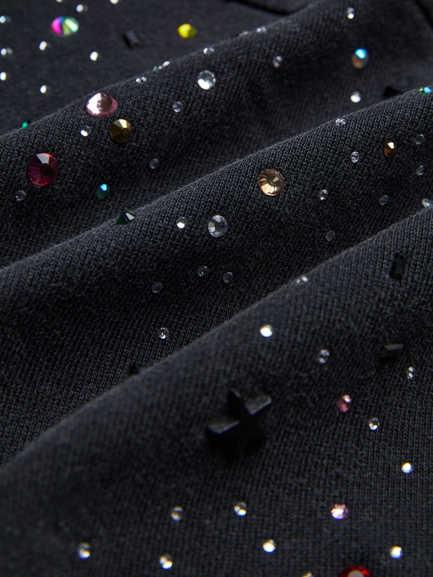 Close-up of the Social Queen Hand-Applied Rhinestone Washed Hoodie featuring black fabric adorned with multicolored hand-applied rhinestones and beads for unique detailing.
