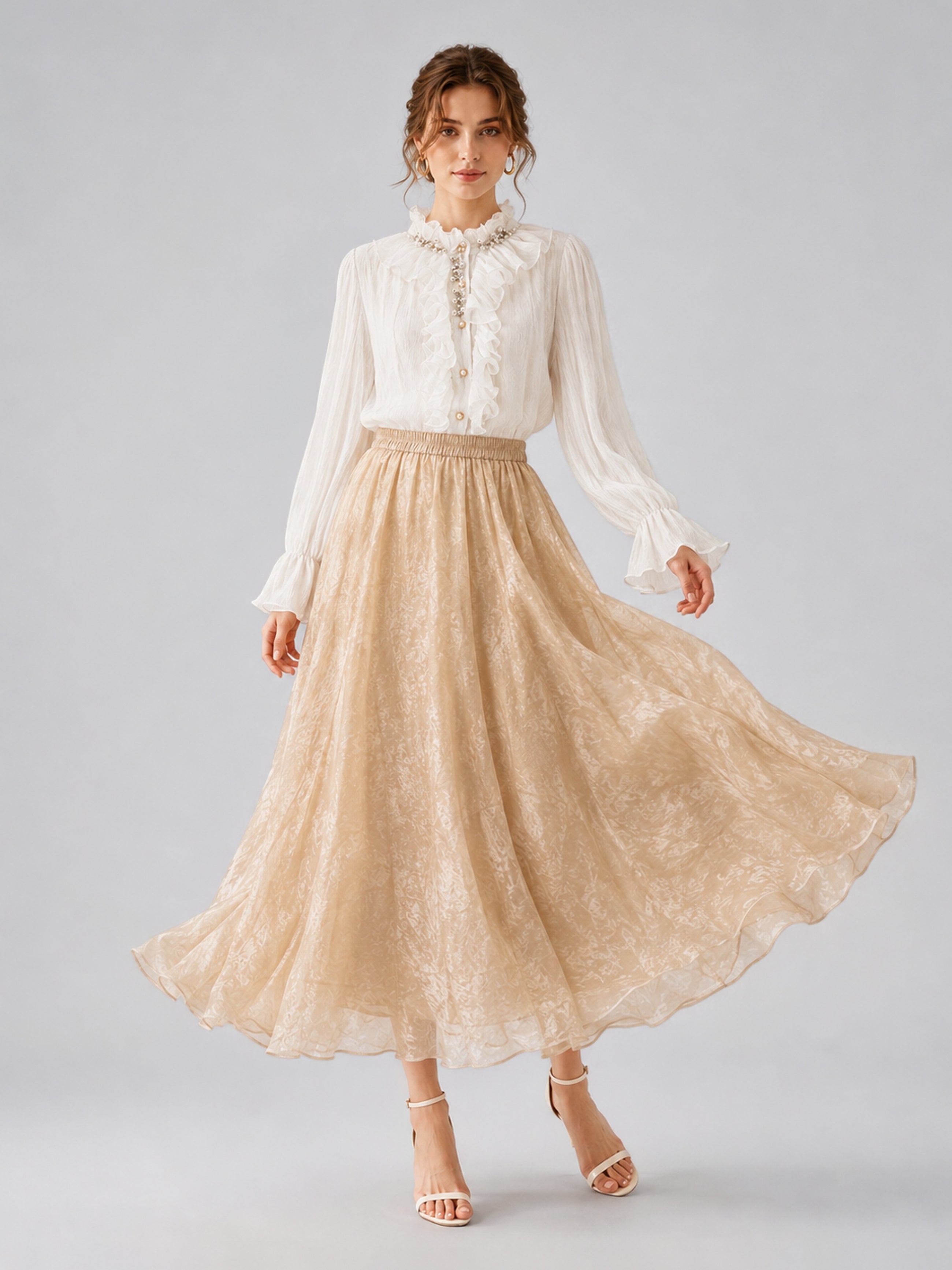 A woman wearing a white ruffled blouse and the Social Queen Jacquard Chiffon Midi Skirt in beige, standing against a plain light background.