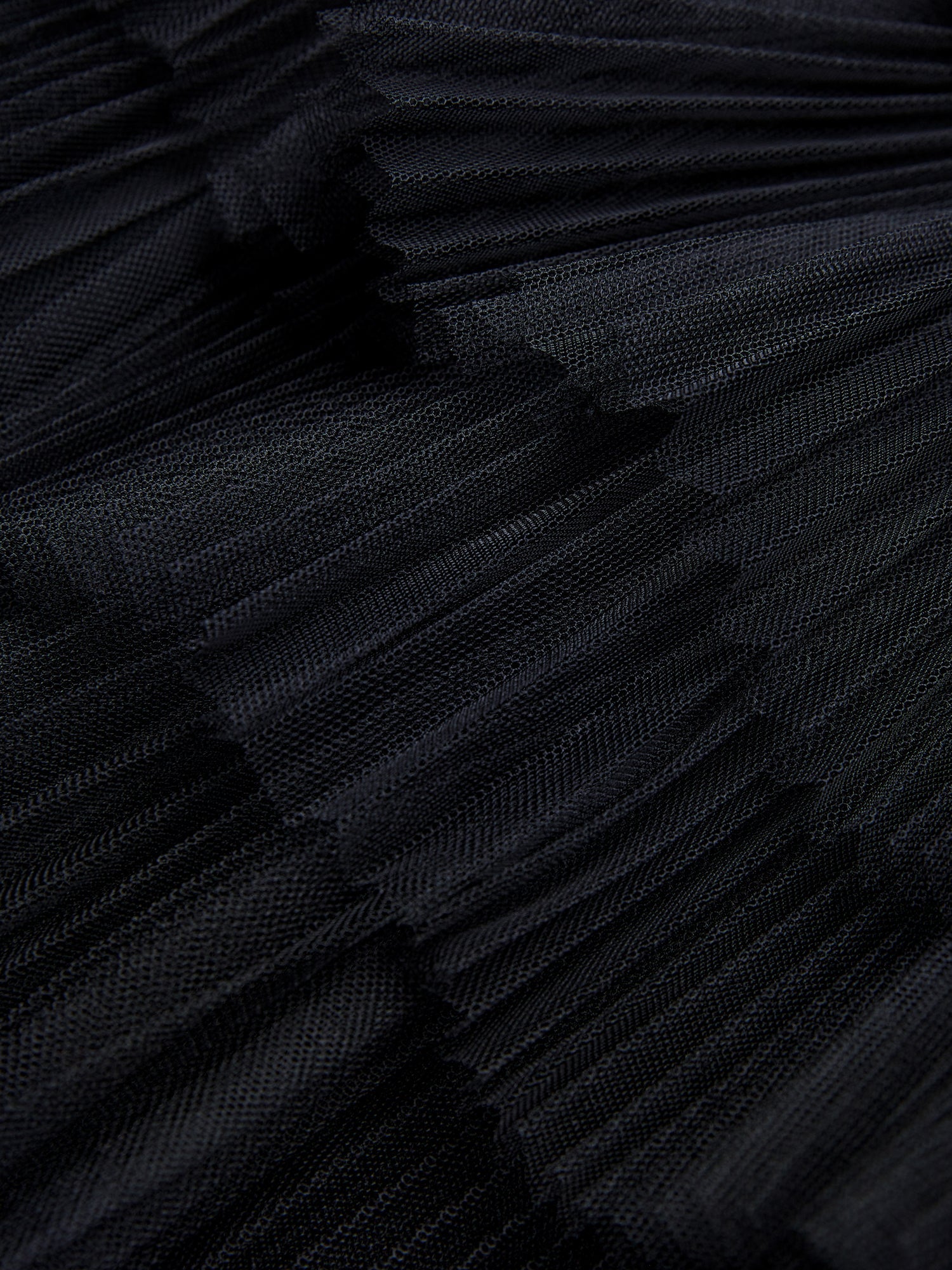 Close-up of the Organza Pleated Skirt by Social Queen, showcasing its detailed black pleated texture and elegant layered design.