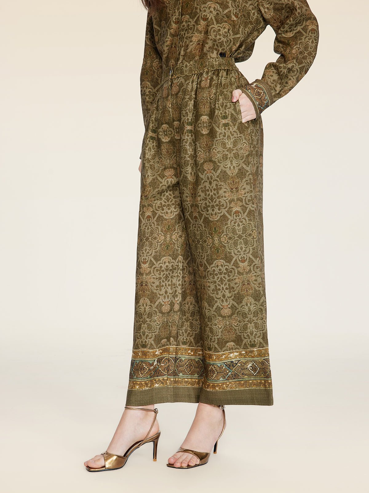 A person wearing Social Queen Printed Linen Straight-Leg Pants and a matching top, paired with gold open-toe heeled sandals, stands against a neutral background.