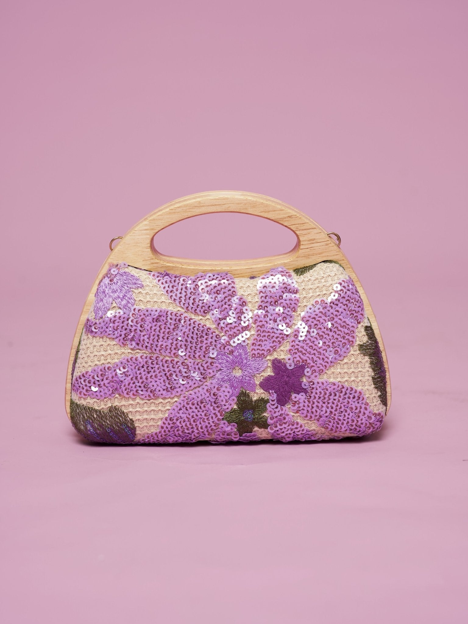 The Social Queen Sequin Embroidered Wooden Handle Bag features purple floral sequin embroidery arranged delicately on a pink background.