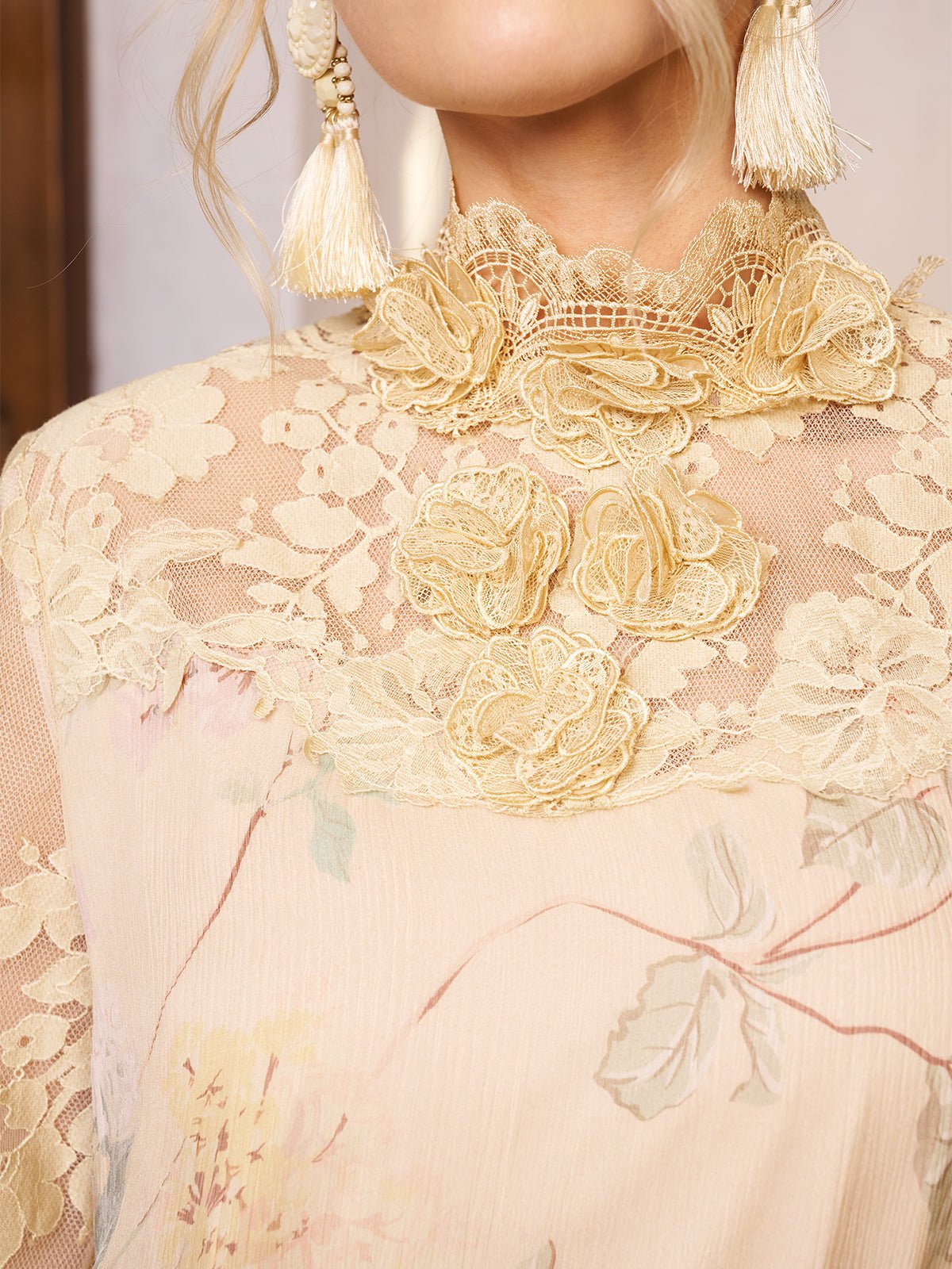 Close-up of a woman wearing the Social Queen Silk Floral & Bird Print Lace Dress, featuring delicate lace and floral details, paired with large tassel earrings.