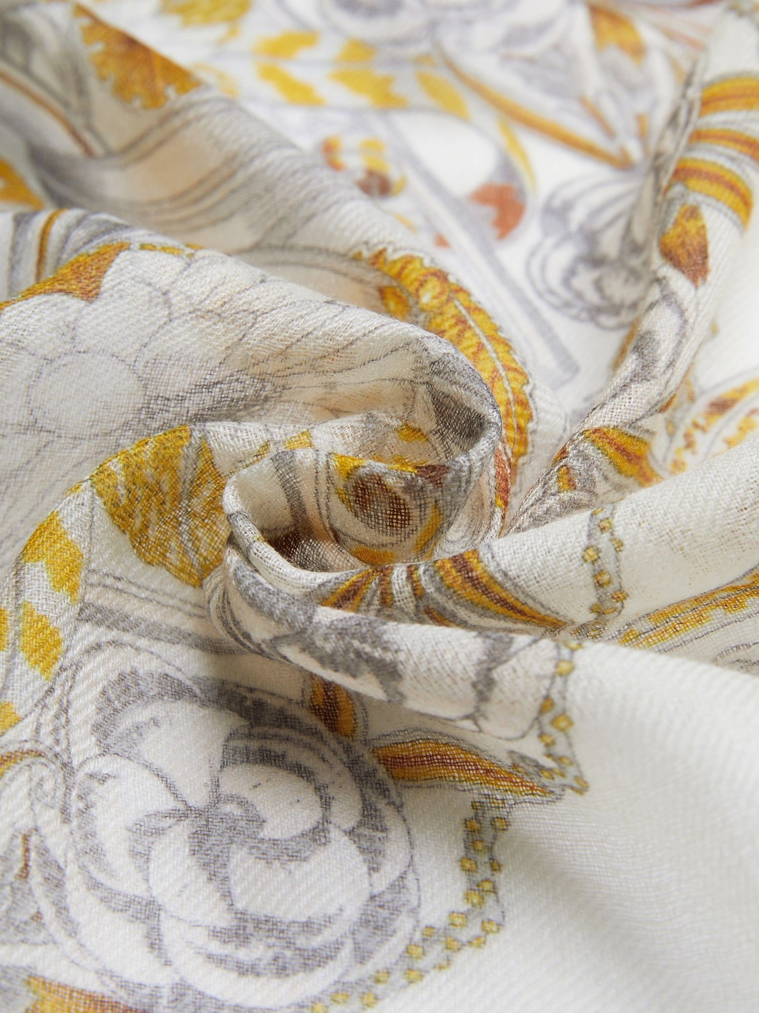 The Social Queen 100% Cashmere Floral Scarf features a vintage-inspired yellow, grey, and white floral swirl pattern on lightweight sheer cashmere, shown loosely gathered at the center.