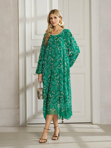 A woman stands indoors by white double doors in the Social Queen 100% Silk Beaded Embroidery Dress, styled with gold earrings, sandals, and a small handbag—a perfect wedding guest look.