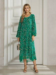 A woman indoors wears the Social Queen 100% Silk Beaded Embroidery Dress with long sleeves, holding a small handbag and pairing it with heeled sandals and large earrings.