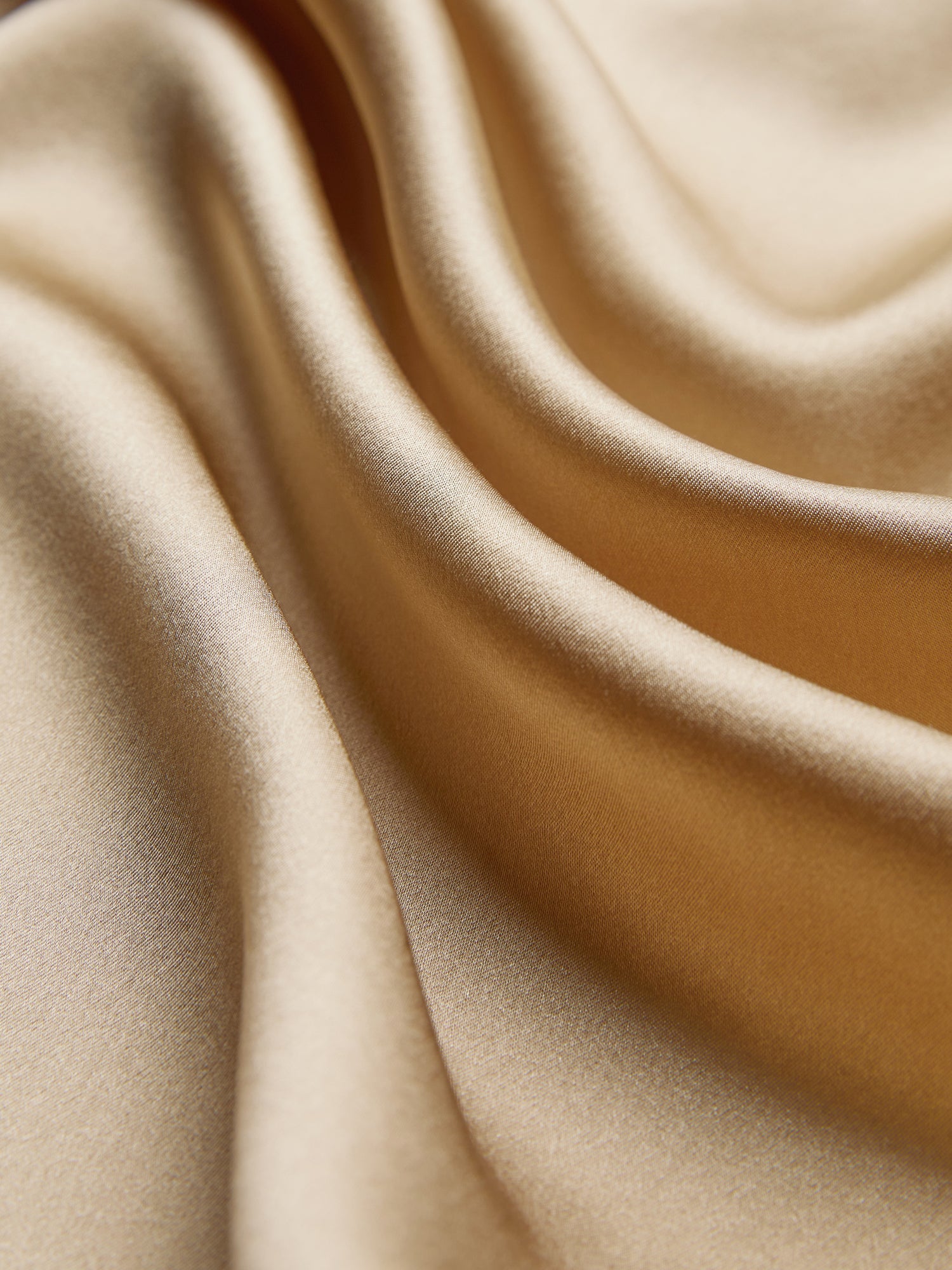 Close-up of the Social Queen 100% Silk Embroidered Lace Satin Blouse, showcasing smooth gold-colored satin with gentle folds, a soft sheen, and delicate hand-embroidered lace detailing.