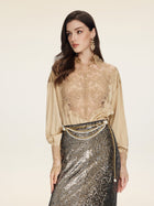 A woman in a Social Queen 100% Silk Embroidered Lace Satin Blouse, pairing it with a metallic sequin skirt and a gold chain belt, poses against a plain light background.