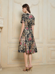 A woman stands indoors with her back to the camera, wearing the Social Queen 100% Silk Jacquard Satin Gold Embroidered Floral Dress and gold high heel sandals.