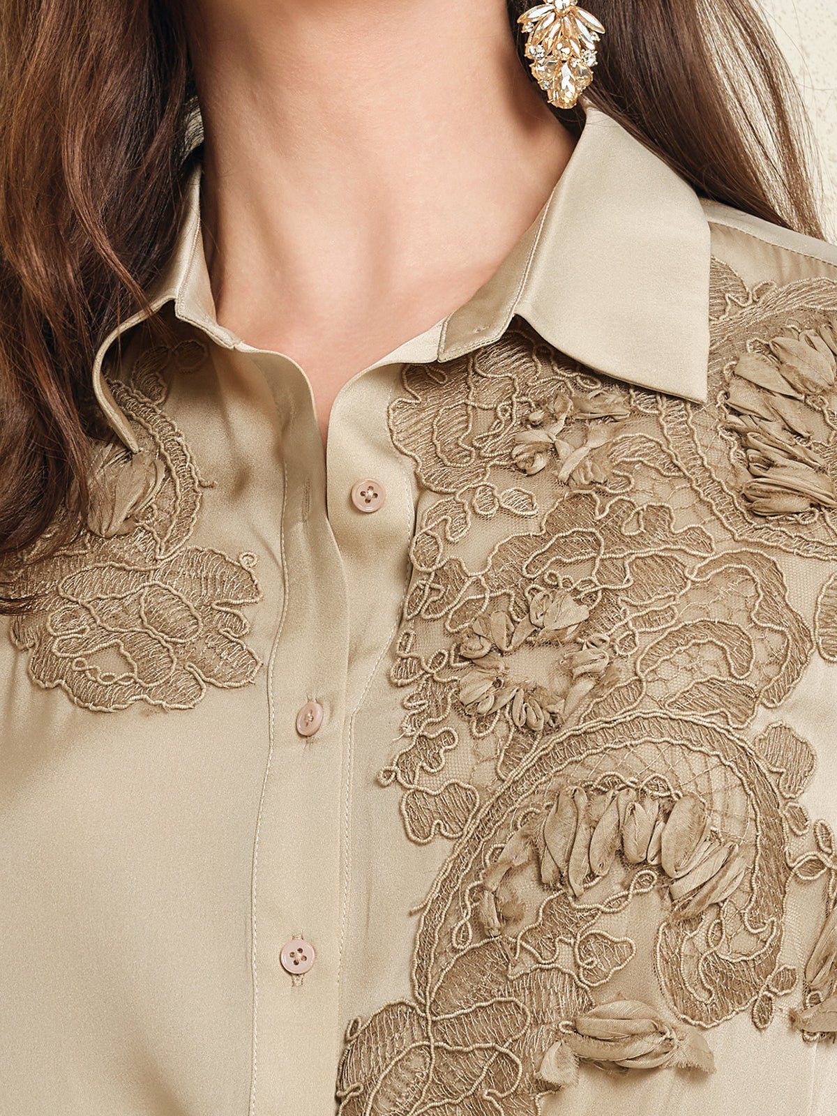 Close-up of the Social Queen 100% Silk Retro Floral Appliqué Satin Blouse, featuring intricate 3D florals in beige, styled with long brown hair and gold statement earrings for a French vintage-inspired look.