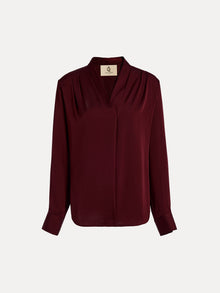 The Social Queen 100% Silk Satin Wrap V-Neck Blouse in burgundy features long sleeves, pleated shoulders, buttoned cuffs, and a cross-front design. Shown on a plain white background, it's ideal for versatile styling.