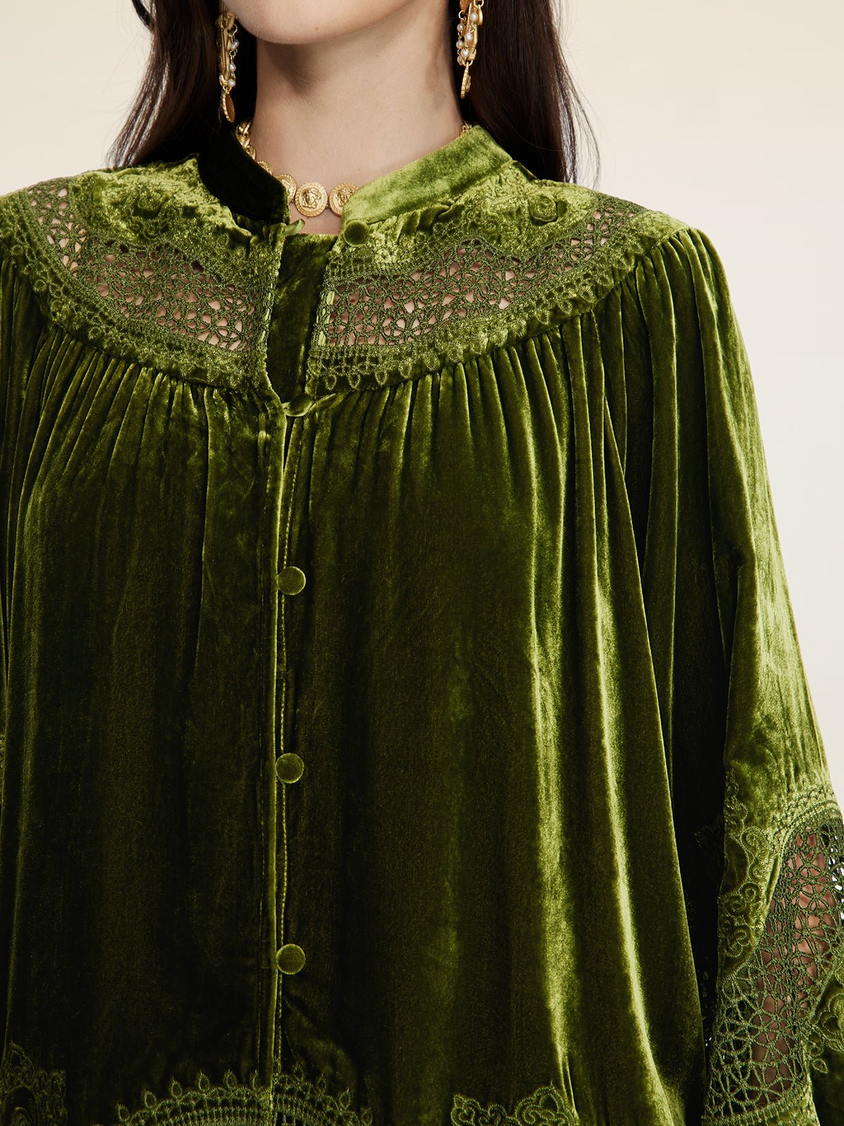 A woman wears the Social Queen 100% Silk Velvet Lace-Panel Blouse, featuring hand-stitched lace, fabric-covered buttons, and gold earrings and a necklace.