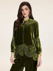 A woman stands against a plain background wearing the Social Queen 100% Silk Velvet Lace-Panel Blouse, featuring hand-stitched lace details on the sleeves and hem.