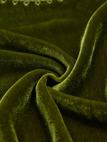 Close-up of the Social Queen 100% Silk Velvet Lace-Panel Blouse in green, highlighting its soft texture, twisted fold, and subtle light reflections for a vintage luxe feel.