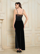 A woman in the Social Queen 100% Silk Velvet & Tulle Mermaid Skirt stands with her back to the camera in a decorated room with light walls, radiating vintage-inspired elegance.