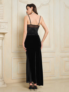 A woman in the Social Queen 100% Silk Velvet & Tulle Mermaid Skirt stands with her back to the camera in a decorated room with light walls, radiating vintage-inspired elegance.