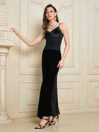 A woman wearing the Social Queen 100% Silk Velvet & Tulle Mermaid Skirt with black heels stands indoors against a cream-colored wall with decorative molding.