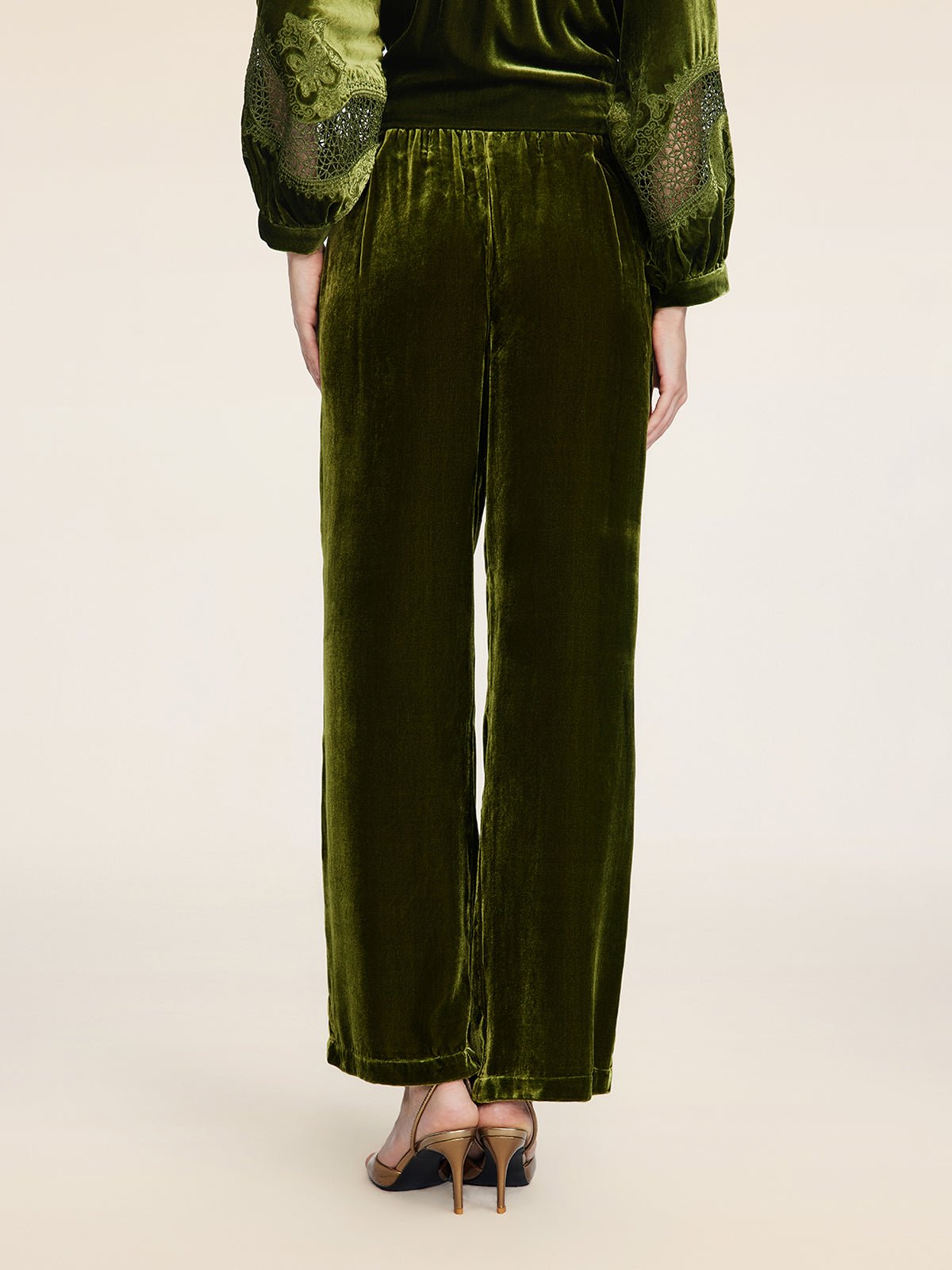 Model wears Social Queen 100% Silk Velvet Wide-Leg Pants in olive green, featuring a loose, straight-leg fit and vintage-inspired style, paired with heeled sandals; shown from the back.