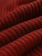 Close-up of folded, ribbed, dark red fabric with a soft texture, perfect for Social Queen's 100% Wool Knit Elastic Trousers.