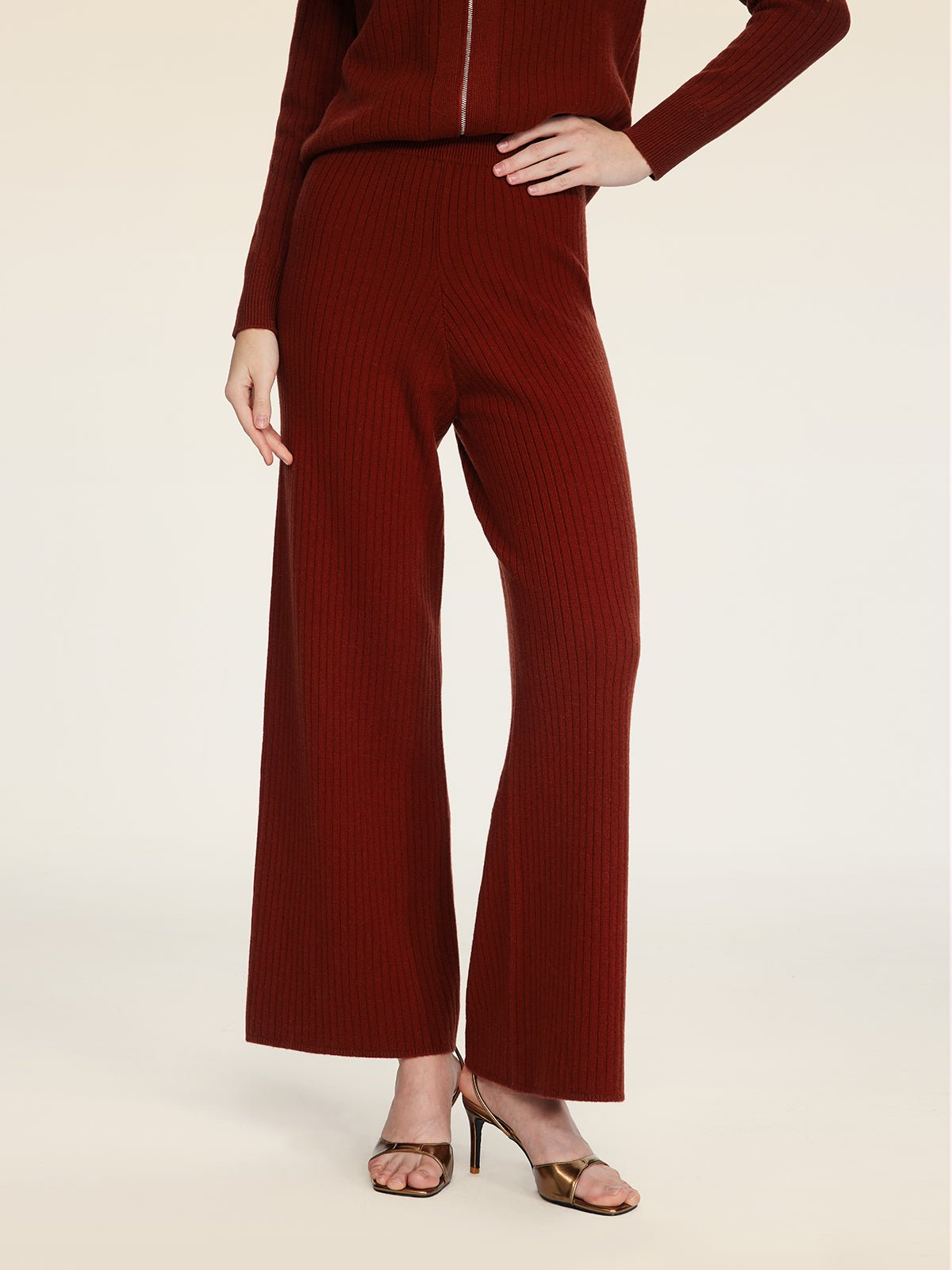 A person in Social Queen's 100% Wool Knit Elastic Trousers and matching top, styled with brown open-toe heels, stands against a plain light background.