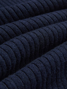 Close-up of dark blue, horizontally ribbed fabric from Social Queen's 100% Wool Knit Elastic Trousers, featuring evenly spaced textured lines and an elastic waistband.