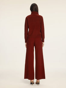 A person stands facing away, wearing the Social Queen 100% Wool Knit Jacket in burgundy with wide-leg pants and heels, against a plain light background.