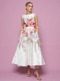 A woman in the Social Queen 3D Floral Embellished Jacquard Gown with a flared skirt and pink heels stands against a pink background.