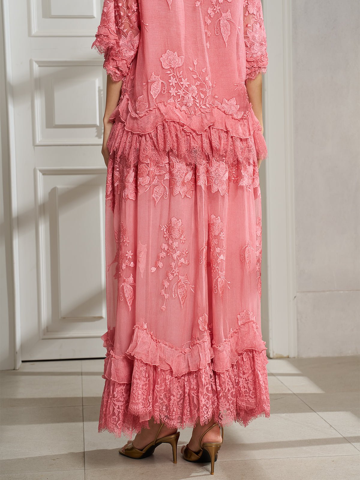 A person wearing the Social Queen 3D Floral Embroidered 100% Silk Ruffle Skirt stands indoors on a tiled floor, facing away from the camera.