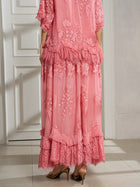 A person wearing the Social Queen 3D Floral Embroidered 100% Silk Ruffle Skirt stands indoors on a tiled floor, facing away from the camera.