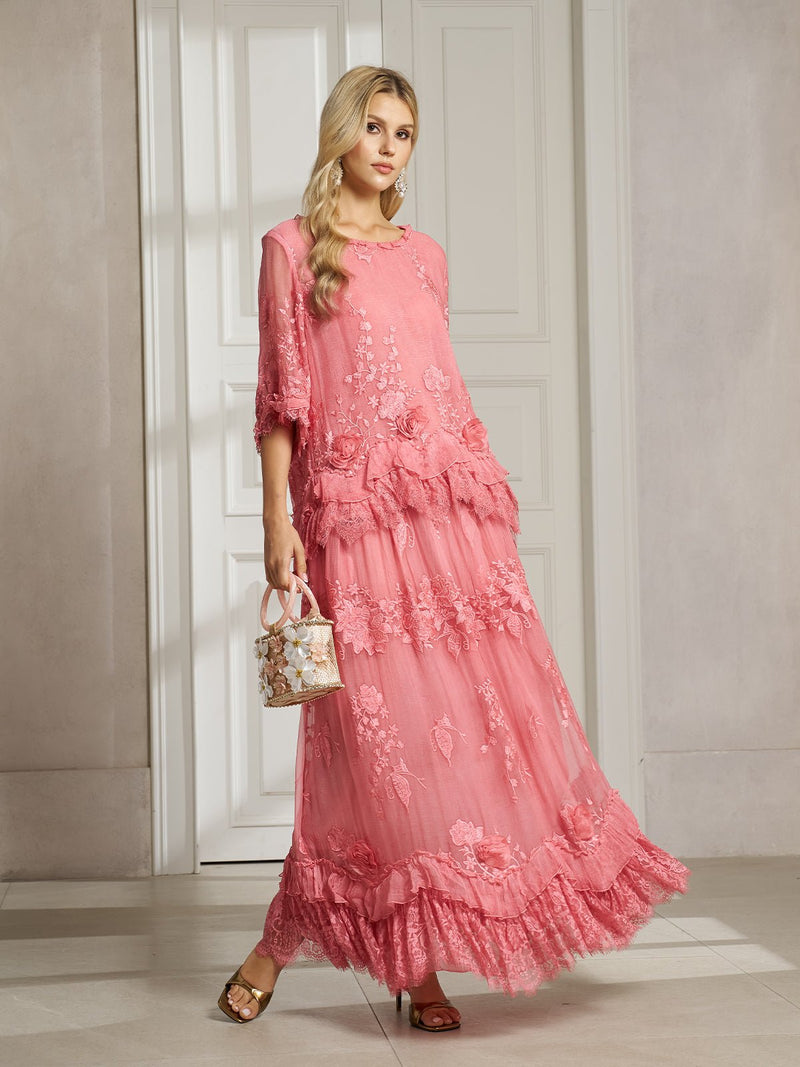 A woman poses indoors in a Social Queen 3D Floral Embroidered 100% Silk Ruffle Skirt, paired with a floral handbag and gold sandals, standing before paneled white doors.
