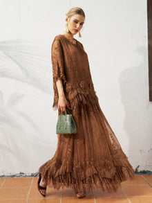A woman in a Social Queen 3D Floral Embroidered 100% Silk Ruffle Skirt and black heels, holding a green handbag, stands against a white wall with a tiled floor.
