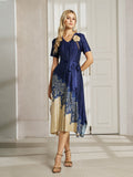 A woman poses indoors in front of white paneled doors, wearing the Social Queen 3D Floral Plissé Satin Lace-Print Dress with navy blue and beige tones, short sleeves, floral details, and strappy heels.