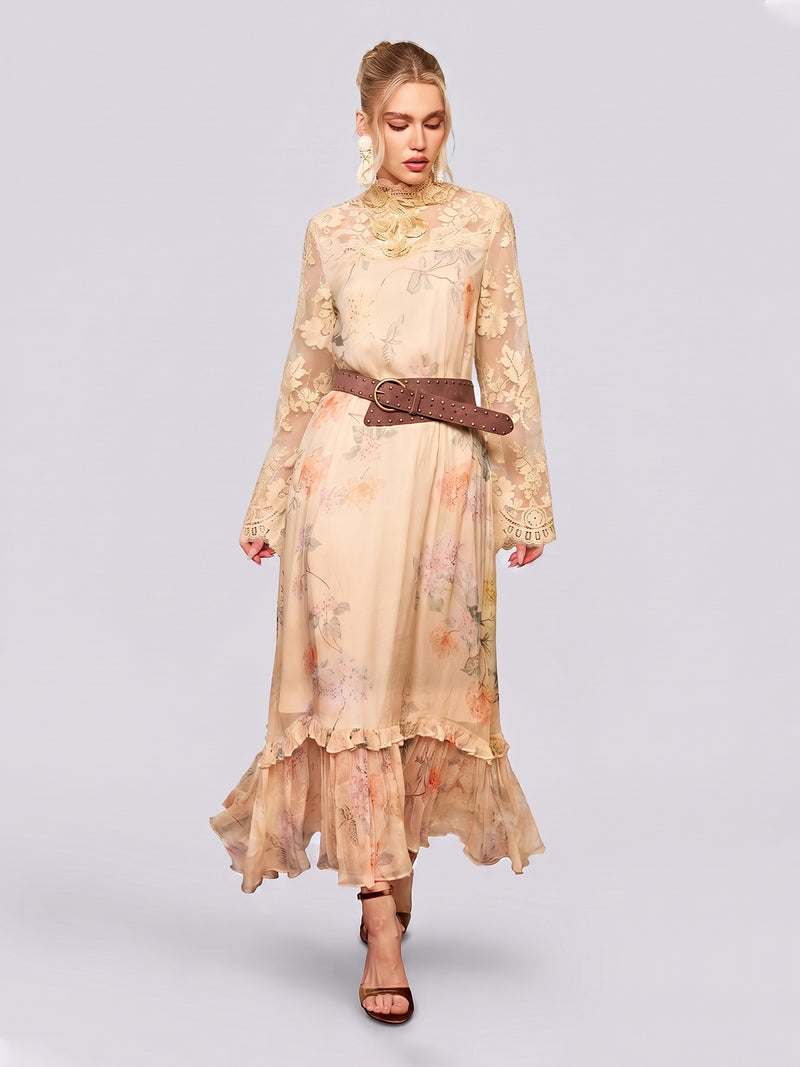 A woman wears the Social Queen Silk Floral & Bird Print Lace Dress—an elegant, long beige style with delicate lace details—paired with a brown wide belt and heeled sandals, standing against a plain light background.