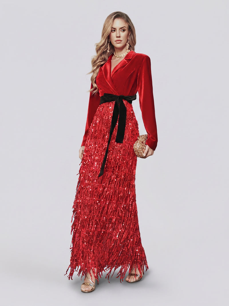 Dressed in the Social Queen Velvet Fringe Sequin Dress with its dramatic long red silhouette, fringed sequin skirt, and chic black belt, this woman completes her look with gold sandals and a gold clutch—an effortlessly glamorous choice for any wedding guest.