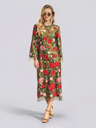 A woman in the Social Queen Rose Embroidered Beaded A-Line Dress—sheer, long, and green with delicate red and pink rose embroidery—stands against a plain light background, creating a perfect look for a stylish wedding guest.