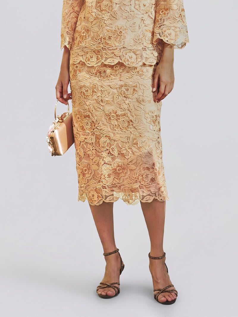 A wedding guest dressed in the Social Queen Floral Embroidered Lace Midi Skirt in light gold, paired with a metallic handbag and dark heeled sandals, stands against a neutral background.