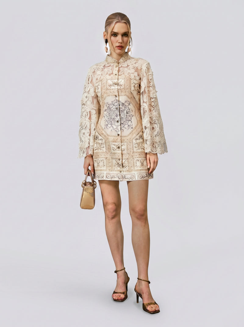 A woman stands against a plain background wearing the Social Queen Baroque Print Floral Appliqué Dress, paired with black heels and a small beige handbag. Her hair is styled up, and she accessorizes with large hoop earrings.