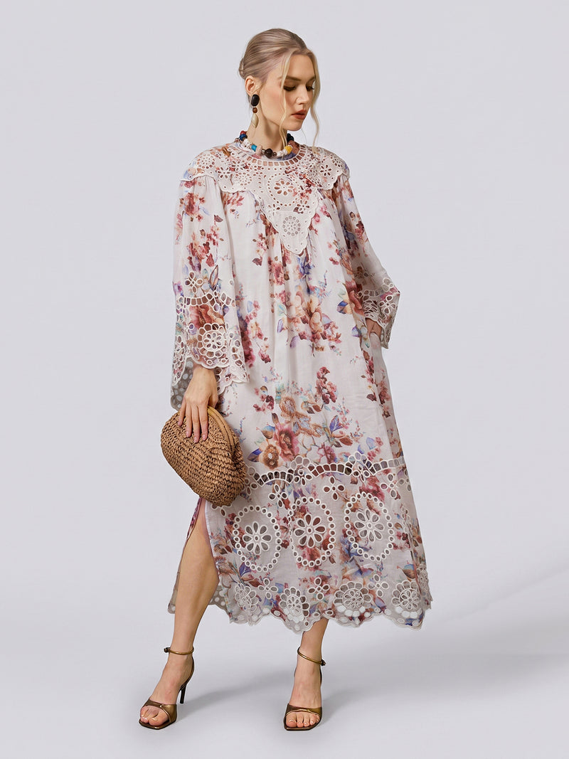 A woman stands against a plain background, wearing the Social Queen Floral Print Cutwork Linen Dress with wide sleeves, paired with strappy high heels and holding a woven clutch.