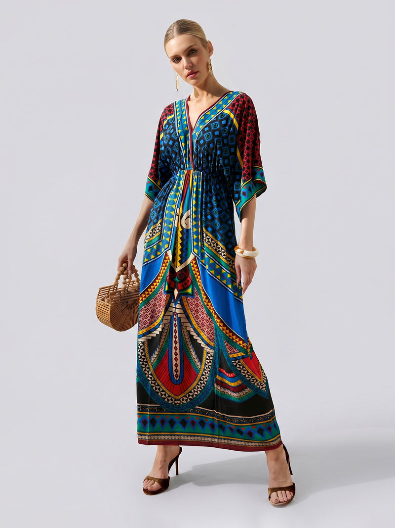 Dressed in the Social Queen Placement Print Chiffon Dress, this woman accessorizes with a woven handbag, hoop earrings, and bangles as she poses against a simple light background—perfect inspiration for effortless vacation style.