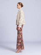 Model wearing a Social Queen Floral Appliqué Embroidered Jacket over a ruffled blouse and a long, floral-embroidered skirt with sequins.