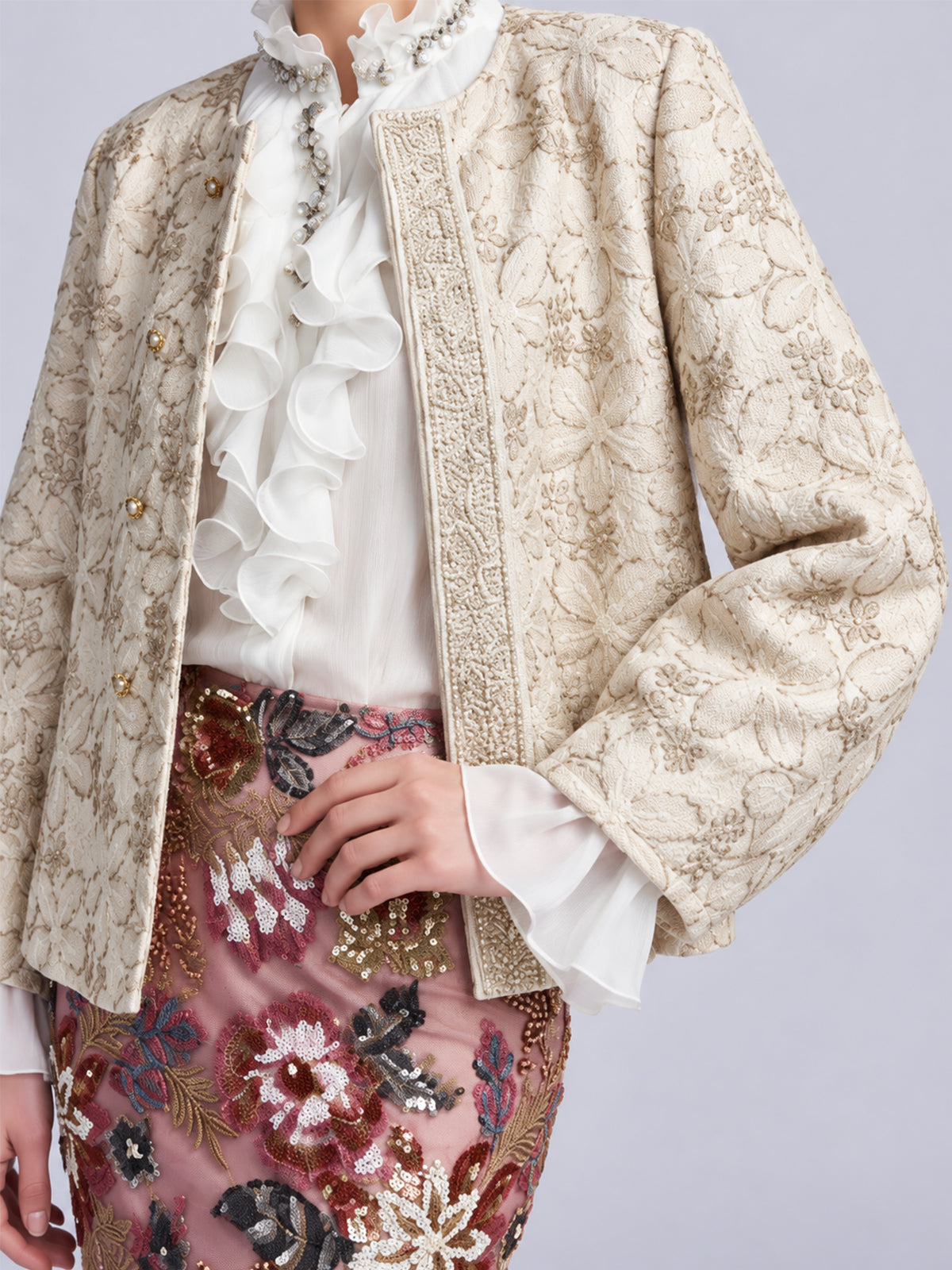 Social Queen Floral Appliqué Embroidered Jacket worn over a white ruffled blouse and a skirt with colorful beaded floral detail.