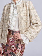 Social Queen Floral Appliqué Embroidered Jacket worn over a white ruffled blouse and a skirt with colorful beaded floral detail.